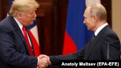 U.S. President Donald Trump (left) and Russian President Vladimir Putin shake hands during a joint press conference following their summit talks at the Presidential Palace in Helsinki on July 16.