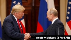 U.S. President Donald Trump (left) and Russian President Vladimir Putin shake hands following their summit talks in Helsinki on July 16. 