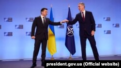 Ukrainian President Volodymyr Zelenskiy (left) and NATO Secretary-General Jens Stoltenberg in Brussels on December 16.