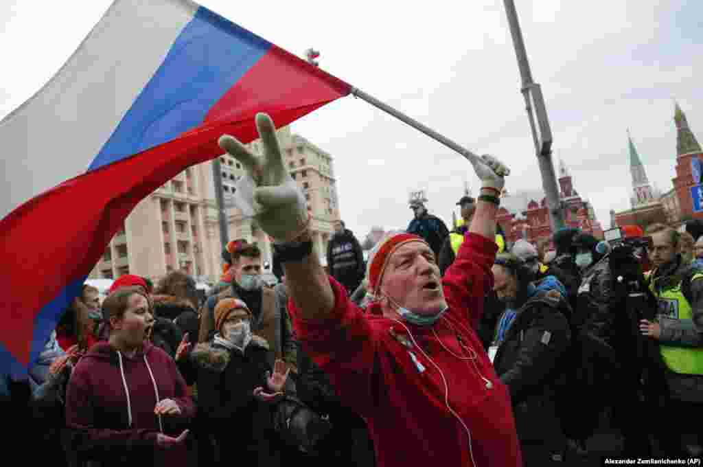 A demonstrator waves a Russian flag during a rally in Moscow in support of jailed opposition leader Aleksei Navalny in Moscow on April 21.