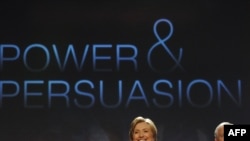 U.S. Secretary of State Hillary Clinton (left) and Defense Secretary Robert Gates take the stage at George Washington University.