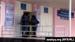 Security forces at a polling station in Zhanaozen in mid-January voting, in the wake of the previous month's deadly clashes