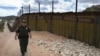 A U.S. security officer patrols along a border fence with neighboring Mexico designed to keep out illegal immigrants. 