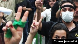 Protests one year ago: supporters of Mir Hussain Musavi show their trademark green.