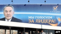 A bus passes a huge election poster of Kazakh President Nursultan Nazarbaev in Astana.