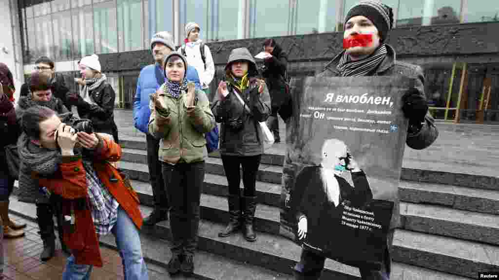 A gay-rights activist holds a placard displaying the image of 19th-century composer Pyotr Tchaikovsky during an unsanctioned protest rally to defend the rights of Russian gays and lesbians in St. Petersburg on April 7.