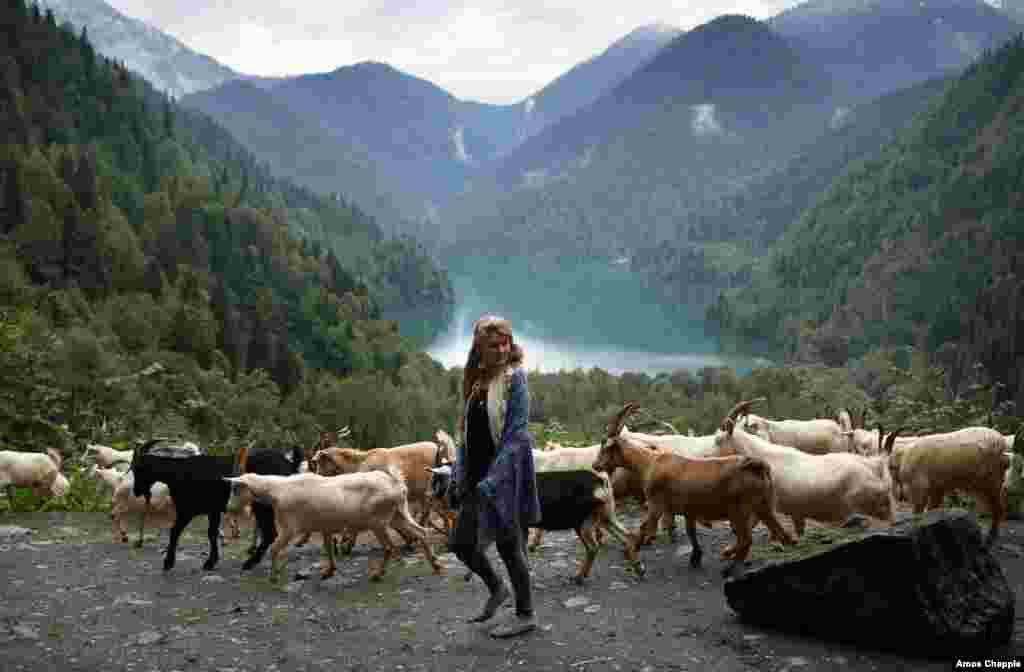 A young Russian tourist at a viewpoint above Lake Ritsa