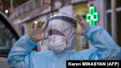 A doctor adjusts a protective mask at a medical center in Yerevan on May 27.