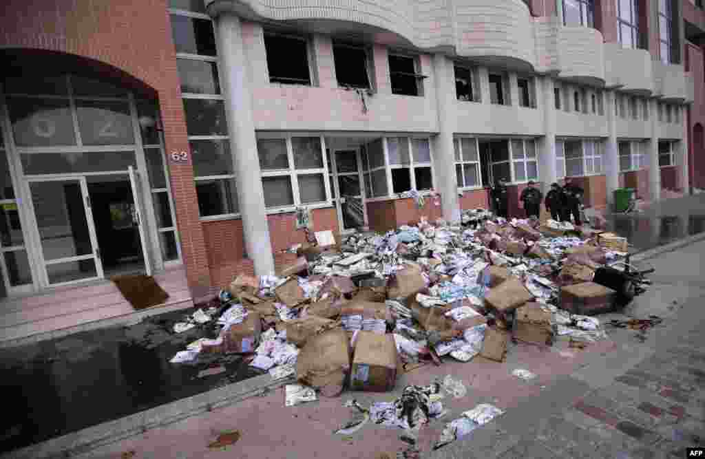 The publication was attacked in the past. Police officers stand in front of the Charlie Hebdo offices after they were destroyed by a petrol bomb attack in Paris in November 2, 2011.