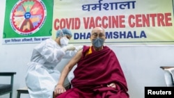 Tibetan spiritual leader the Dalai Lama receives a dose of COVID-19 vaccine at a vaccination center in Dharamsala, India, on March 6.