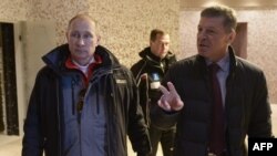 Russian President Vladimir Putin (left) listens to the head of the Sochi 2014 Olympic preparatory commission, Russian Deputy Prime Minister Dmitry Kozak, during a January 3 visit to one of the 2014 Winter Olympics venues.