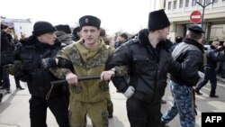 Pro-Russian volunteers stand guard in front of Crimea's parliament building during a pro-Russian rally in Simferopol on March 6.