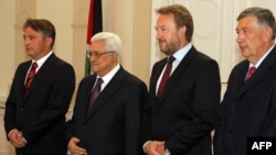 Palestinian President Mahmud Abbas (second from left) is welcomed by members of Bosnian Presidency, Zeljko Komsic (left), Bakir Izetbegovic (second from right), and Nebojsa Radmanovic (right) upon his arrival for bilateral talks in Sarajevo on August 15.