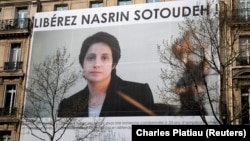 A banner with a giant portrait of jailed Iranian lawyer Nasrin Sotoudeh is seen on the headquarters of the French National Bar Council, which demanded her release, in Paris in March.