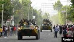 Armored vehicles patrol in Osh amid the rioting on June 11.