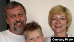 Iryna Khalip (right) with jailed husband Andrey Sannikau and their son Daniil. 