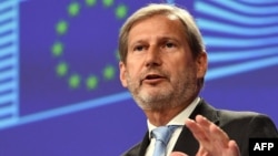 EU Enlargement Negotiations Commissioner Johannes Hahn speaks at a news conference in Brussels on June 12.