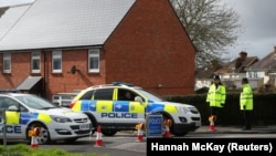 Police officers guard the cordoned-off area around the home of former Russian intelligence officer Sergei Skripal in Salisbury, Britain, on April 3.