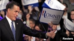 U.S. Republican presidential hopeful Mitt Romney greets supporters at his primary night rally in Manchester, New Hampshire. 