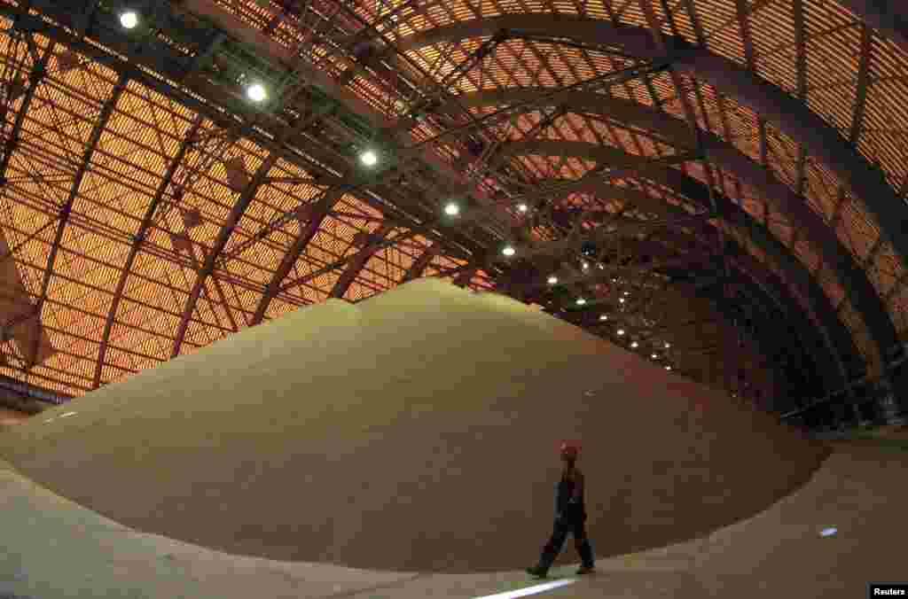 An employee at an above ground pile of processed potassium salts at a Uralkali potash mine.