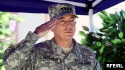 Newly appointed ISAF commander, General David Petraeus, stands at attention during a change-of-command ceremony in Kabul today.