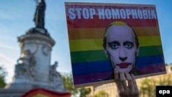 A demonstrator holders a placard depicting Russian President Vladimir Putin to denounce the reported detention, torture, and killing of gay men in Chechnya during a protest in Paris last month.