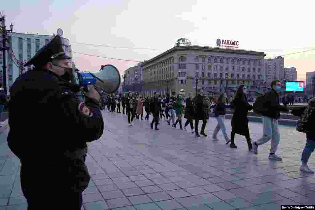 A police officer observes a rally in the Far East city of Khabarovsk, the scene of massive protests last year against the removal of the governor.