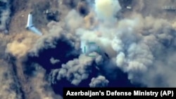 In this still taken from video released by Azerbaijan's Defense Ministry on October 1, an unmanned aerial vehicle flies over a site where Azerbaijan's forces are allegedly attacking Armenian military positions. 