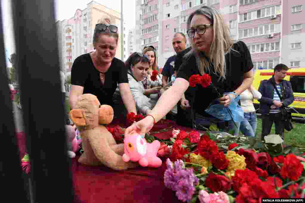 A woman places a toy at a makeshift memorial for victims of the shooting at Kazan&#39;s School No. 175 on May 11.