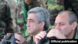 Armenian President Serzh Sarkisian (left) watches military exercises in Nagorno-Karabakh on October 22.