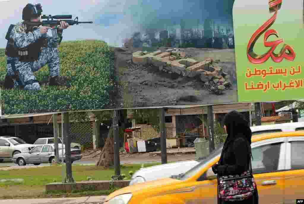 In Baghdad, a&nbsp;billboard depicting a member of the Iraqi security forces aiming his weapon against unseen militants.