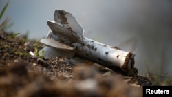 A fragment of an artillery shell illustrates the fighting between ethnic Armenian soldiers and Azerbaijani armed forces as a humanitarian cease-fire takes effect.