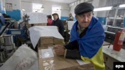 Members of a local election commission inspect ballot papers in Mariupol, Ukraine, where polling remained closed.