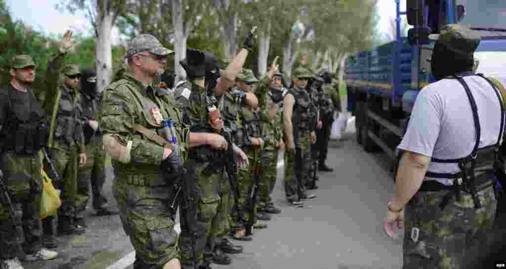 Pro-Russian separatists of the self-proclaimed &quot;Vostok Battalion&quot; preparing to board a truck at a checkpoint on the outskirts of the city of Donetsk on May 25.