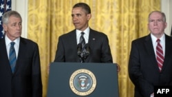 U.S. President Barack Obama is flanked by his nominees for CIA director, John Brennan (right), and defense secretary, Chuck Hagel, in Washington on January 7.