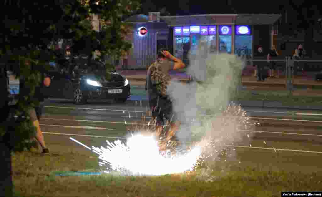 An explosive detonates next to a man in Minsk on August 10.