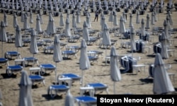 A man walks near empty sunbeds at Sunny Beach resort on Bulgaria's Black Sea coast on June 23.