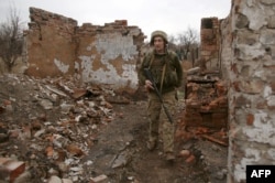 A Ukrainian soldier patrols near the front line with Russia-backed separatists near the city of Marinka in the eastern Donetsk region on April 12.