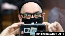 Russian theatre and film director Kirill Serebrennikov read a poem from his cell phone at the closing of his trial in Moscow on June 22. 