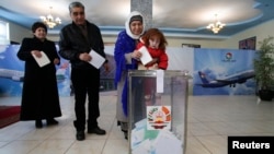 People line up to cast their votes during Tajik parliamentary elections in Dushanbe on March 1.