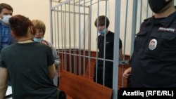 Azat Miftakhov in the defendant's cage at a court hearing in Moscow earlier this week. 