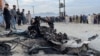 People stand at the site of a deadly bomb blast in Kabul on May 8. 