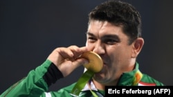 Dilshod Nazarov stands on the podium during the medal ceremony for the men's hammer throw final during the athletics at the Rio 2016 Olympic Games at the Olympic Stadium in Rio de Janeiro in August 2016.