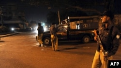 Pakistani police keep watch at a security checkpoint in Karachi on February 17, after military officials confirmed the arrest of Mullah Bardar.