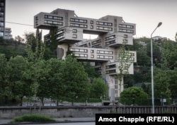 The former Highways Ministry overlooks the Mtkvari River. The Jenga-like structure houses the headquarters of the Bank of Georgia.