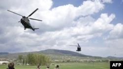 French KFOR watch helicopters take off near Mitrovica, Kosovo.