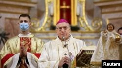 Archbishop Tadeusz Kondrusiewicz conducts a service on Christmas Eve at a cathedral following his arrival in Minsk on December 24. 