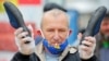 An opposition supporter in Minsk holds a pair of slippers during a rally on May 31 to support a free presidential election in August.