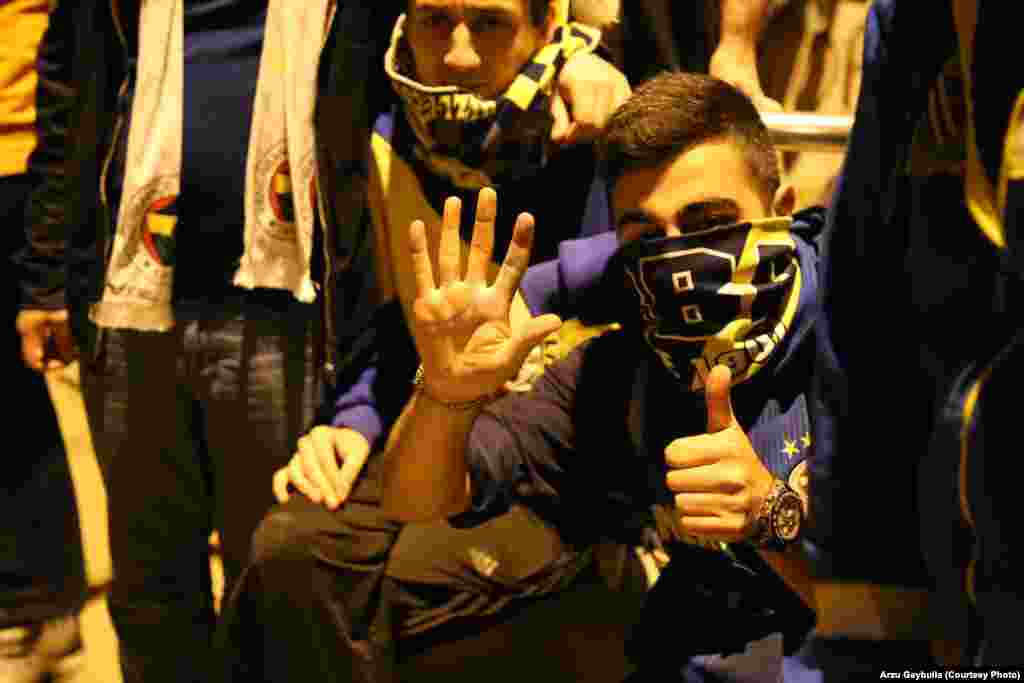 A Fenerbahce fan late at night on a sidestreet off of Taksim Square