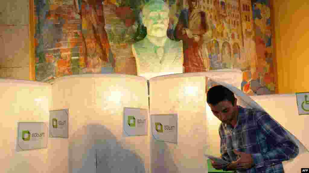 A man leaves an election booth at a polling station in Tbilisi.